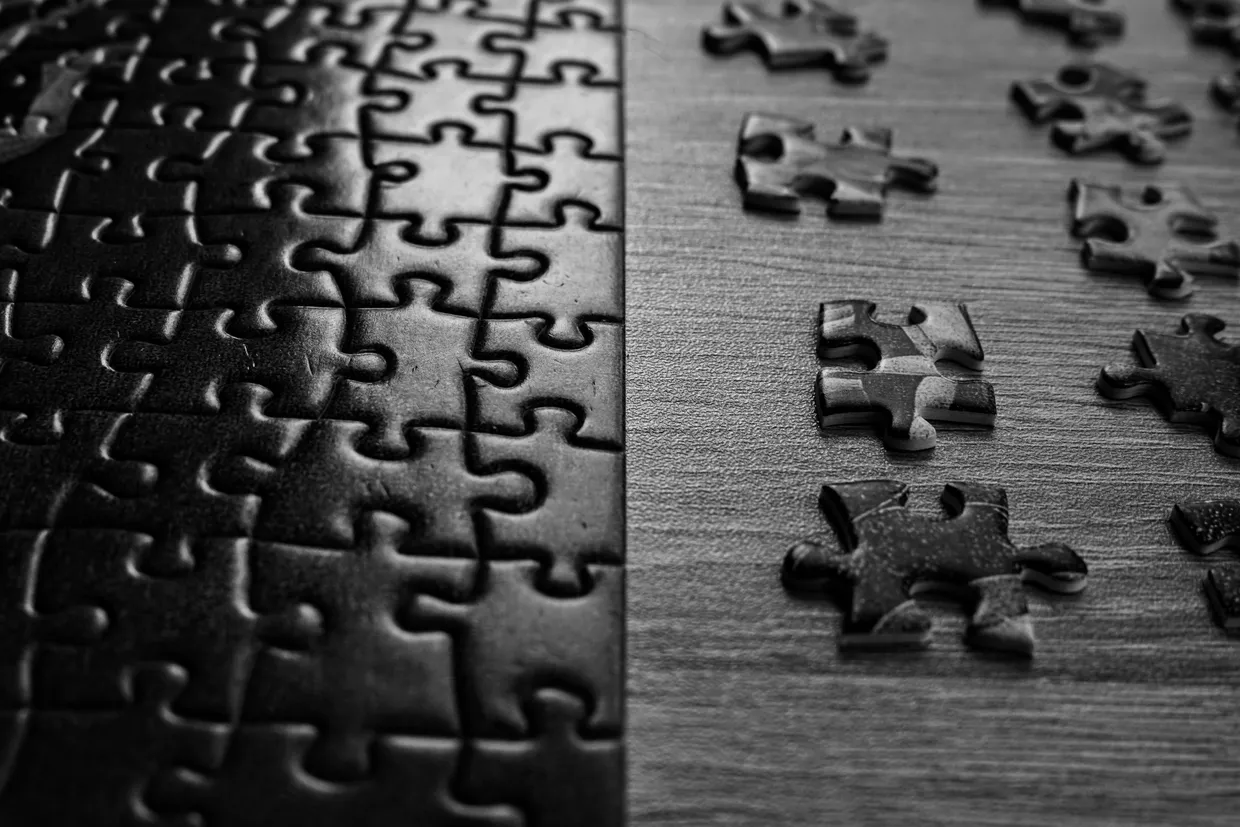 a close up of a puzzle on a table by Daria Glakteeva