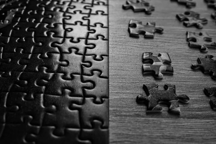 a close up of a puzzle on a table by Daria Glakteeva